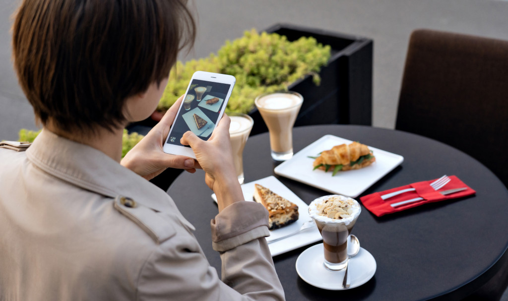 influencer taking photos of her food t the table