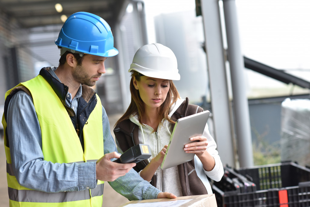 woman holding her ipad up to let the man see it