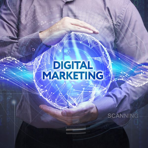 A businessman holding a blue DIGITAL MARKETING sphere
